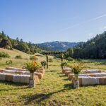 Hay bales set out for wedding guests under a blue sky at Bell Valley Retreat — Anderson Valley, Mendocino County, California