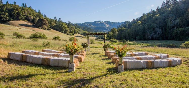 hay bales in the sunny meadow for a lovely wedding at The Toll House at Bell Valley Retreat in Anderson Valley, Mendocino County, California